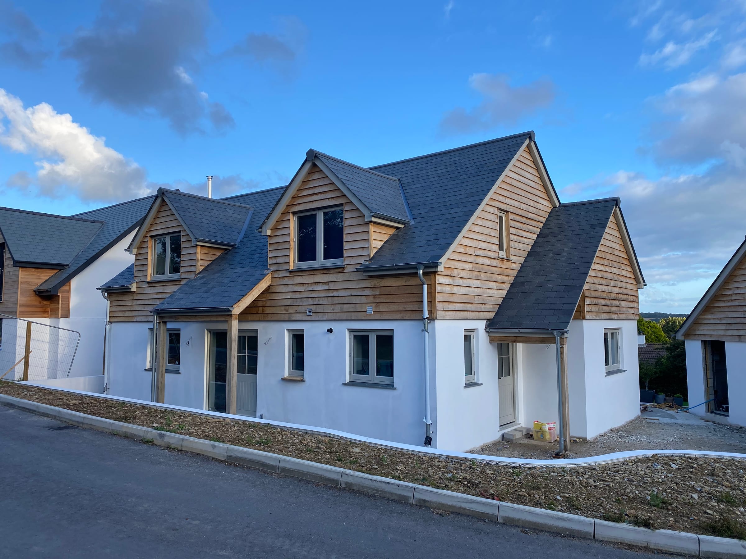 Mitchell & Andrew Building Services — A pair of new homes in render and cedar cladding