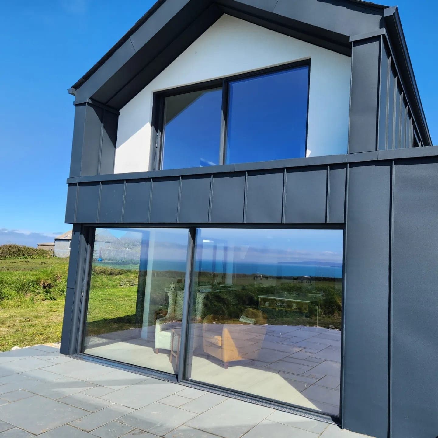 Mitchell & Andrew Building Services — Contemporary home with standing-seam cladding and sea views