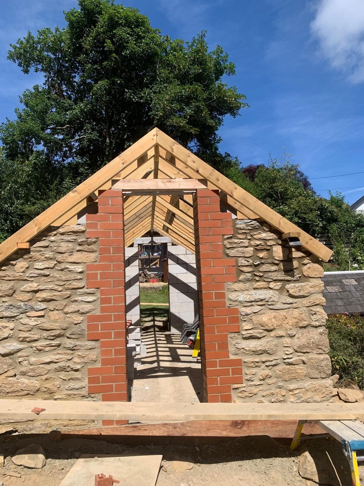 Stone gable, brick opening and new roof timbers during building work